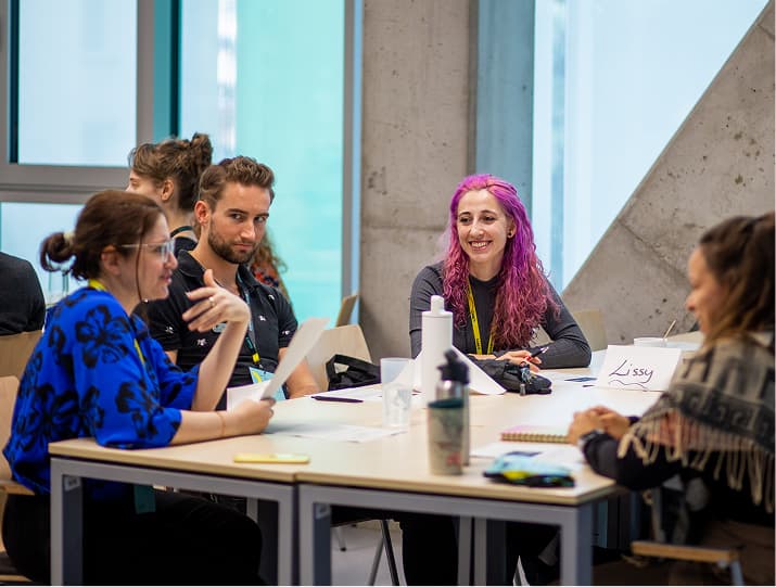 Participants at CARE Conference sitting together around a table