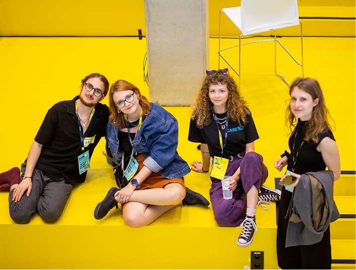 Participants at CARE Conference during a break, talking on the stairs